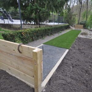 Horseshoe court built with synthetic grass bluestone screening and pressure treated lumber in Dix Hills NY