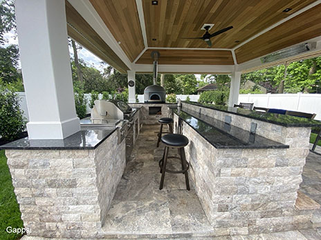 Custom-built-pavilion-with-U-shaped-cooking-island-finished-with-travertine-veneer-and-granite-countertops-in-Wantagh-Nassau-County-NY