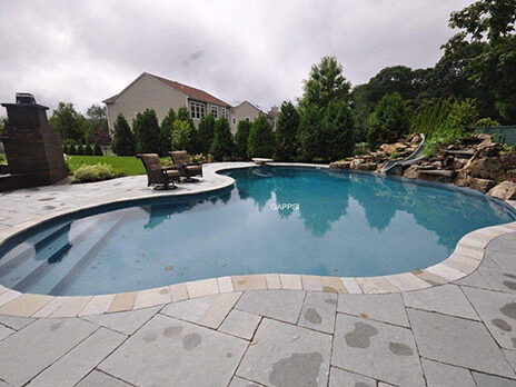 custom-freeform-vinyl-pool-with-natural-stone-waterfall-and-limestone-patio-and-coping-Saint-James LI custom-freeform-vinyl-pool-with-natural-stone-waterfall-and-limestone-patio-and-coping-Saint-James LI
