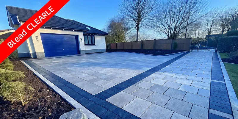 A small paver driveway with a modern pattern and contrasting border for big curb appeal.