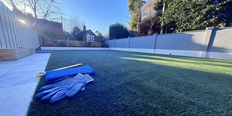 Getting a quote for turf installation with tools on a prepped lawn.