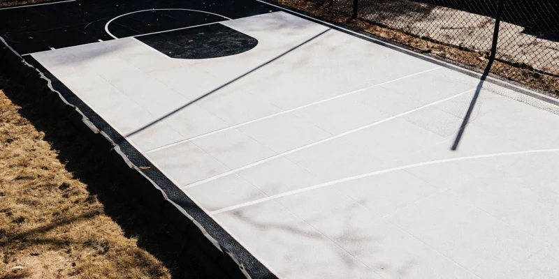 Professional backyard game court transformation in Hempstead, NY featuring a multi-sport surface.