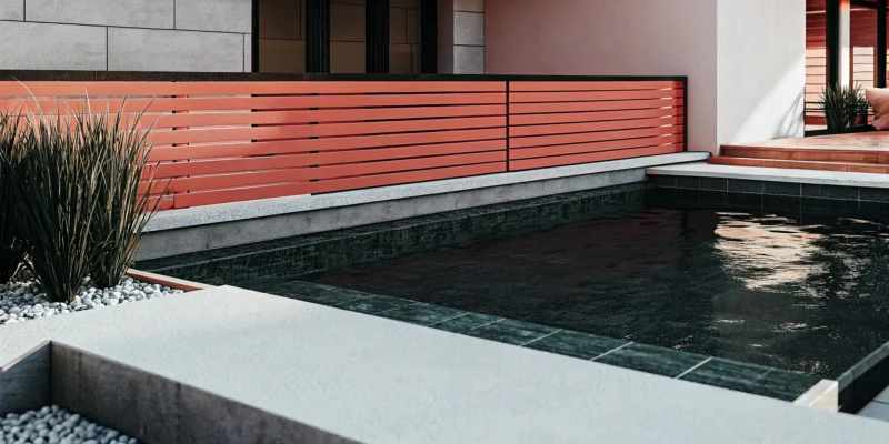 A finished vinyl inground pool installation with a modern patio and landscaping.