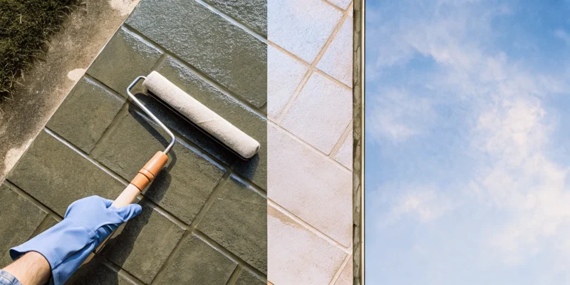 Hand with a roller applying stain to pavers before sealing them for long-lasting protection.