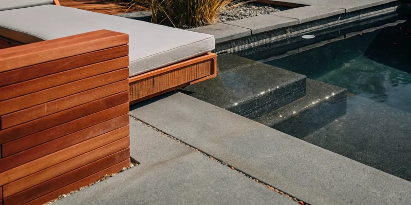 Two-inch thick porcelain pool copings and step treads for a modern pool in Long Island, NY.