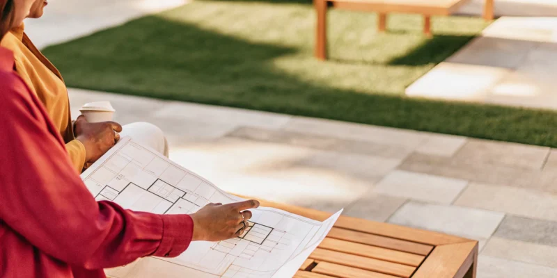 A Cambridge pavers installer on Long Island, NY, reviewing design plans for a new patio.