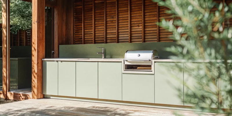 Serene powder coated aluminum outdoor kitchen cabinets with a built-in grill on a modern patio.