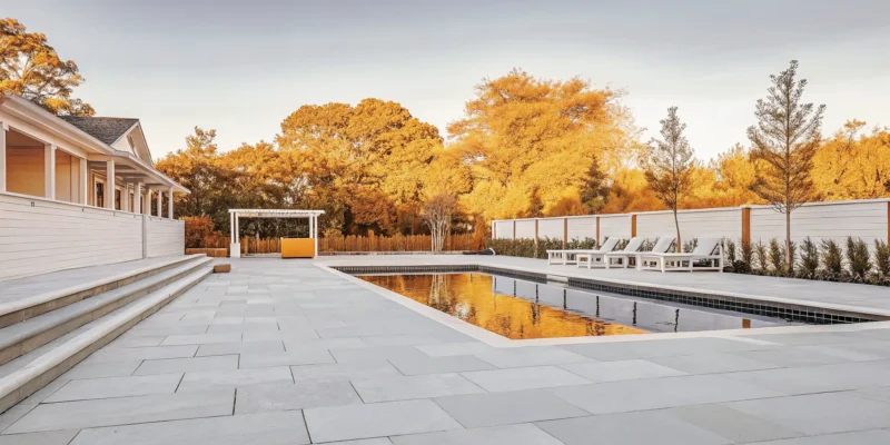 Luxury custom gunite swimming pool with travertine coping and waterfall feature
