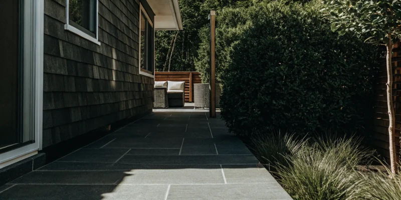 Outdoor tile patio installed by a Long Island contractor with modern stone pavers and seating.