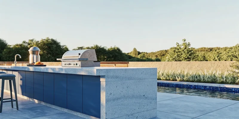 Elegant outdoor kitchen with natural stone island and built-in grill in a lush Long Island backyard