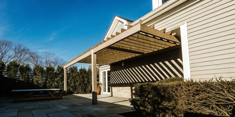 Backyard pergola attached to a Long Island home, built by a professional contractor.