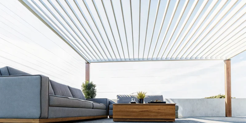 A modern louvered roof pergola shading a comfortable patio seating area.