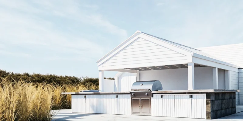 A modern outdoor kitchen pavilion on Long Island with a built-in stainless steel grill.