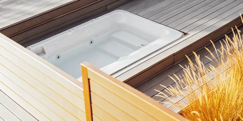 Modern sunken swim spa deck with clean lines and natural wood accents.