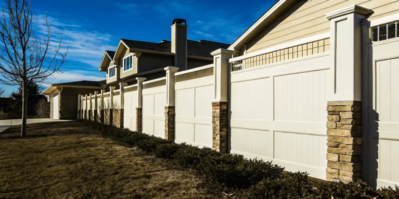 A white vinyl privacy fence, an example for a vinyl fencing cost calculator.